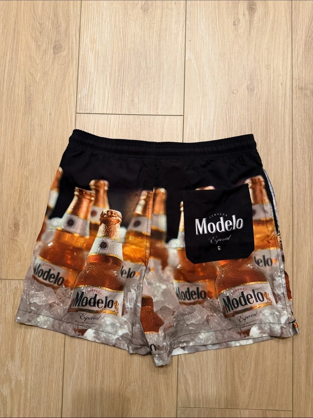 Modelo Bottle Print Men’s Swim Trunks in Black and Amber